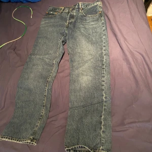 Mörk blåa jeans - Jeansen är ifrån Levis och är väldigt fina rak passform och knappt använda. Dom har flera knappar istället för dragkedja men det syns inte då det är tyg över. Dom har en fin brodering på bakfickorna. Storlek 38