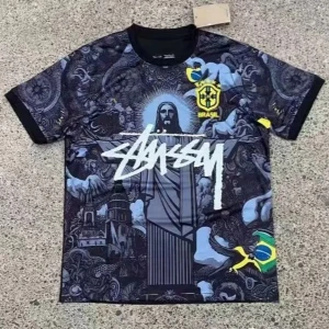 Svart Brasilien t-shirt från Stussy - Unik svart t-shirt med Brasilien-tema från Stussy. Tryck med Kristusstatyn, brasiliansk flagga och stora grafiska detaljer. Rund hals och korta ärmar. Perfekt för dig som gillar streetwear och fotbollsinspirerad stil.