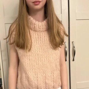 Stickad väst med polokrage från Zara - Säljer en ljusrosa stickad väst från Zara med polokrage. Västen är grovstickad och har en avslappnad passform som passar perfekt till lager-på-lager-stil. Supermjuk och trendig detalj till din garderob.