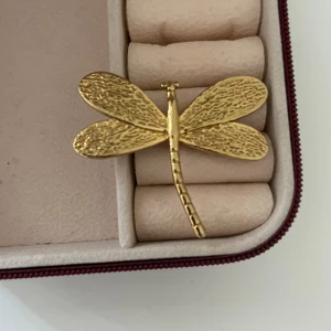 Guldig trollsländsring - Snygg ring i guldfärgad metall formad som en trollslända med detaljerade vingar. Den har en elegant och naturinspirerad design som sticker ut.