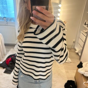 Randig stickad tröja i vitt och svart - Säljer denna stickade tröja med svarta och vita ränder, i mycket bra skick!💕