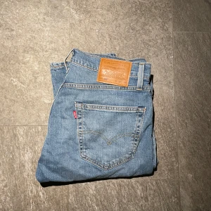 Levis 502 jeans i ljusblå denim - Levi’s 502 jeans – stl 32/34, ljusblå  Säljer ett par Levi’s 502 jeans i storlek 32/34. Modellen har en modern, något avsmalnande passform som är både bekväm och stilren. Klassisk ljusblå denim, perfekt för en avslappnad men snygg look.  ✔ Märke: Levi’s ✔ Modell: 502 (Regular Taper Fit) ✔ Storlek: 32/34 ✔ Färg: Ljusblå denim ✔ Skick: Mycket bra – inga tecken på användning  Finns för avhämtning eller kan skickas! Skicka PM vid intresse.