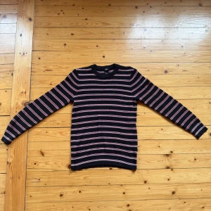 Randig stickad tröja från H&M - Säljer en svart stickad tröja från H&M i storlek S. Perfekt för dig som gillar en klassisk men ändå chill stil.