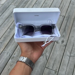 Gråa CHIMI solglasögon 04 - Snygga solglasögon från CHIMI med transparent grå båge och mörka. Kommer med original vit CHIMI-fodral.