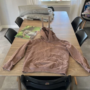 Beige hoodie från Lyle & Scott - Säljer en beige hoodie från Lyle & Scott Junior med klassisk huva och magficka. Tröjan har långärmade ärmar och en liten gul logga på bröstet. Perfekt för chill dagar och enkel att matcha med jeans eller joggers.