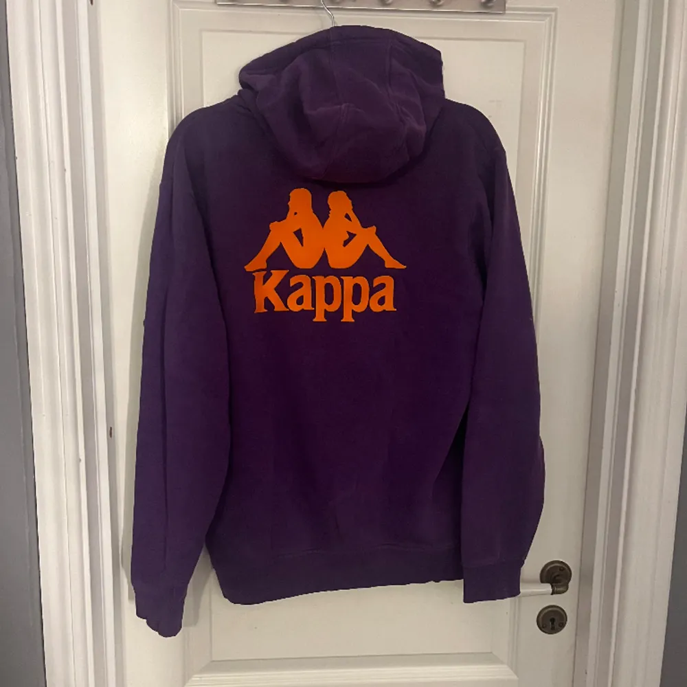 En lila hoodie från kappa med ett litet oranget tryck på bröstet och ett stort på ryggen. Säljer då den inte kommer till användning. Storlek L men skulle säga att den mer sitter som M.. Hoodies.