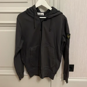 Stone island hoodie - Stone island hoodie i gott skick 9/10 I en ungefär grön grå färg  Storlek: M/medium Endast tröjan följer med ingen box osv tyvärr  Qr scan finns helt äkta Fraktar samma dag som köp Pris kan diskuteras vid snabb affär. 