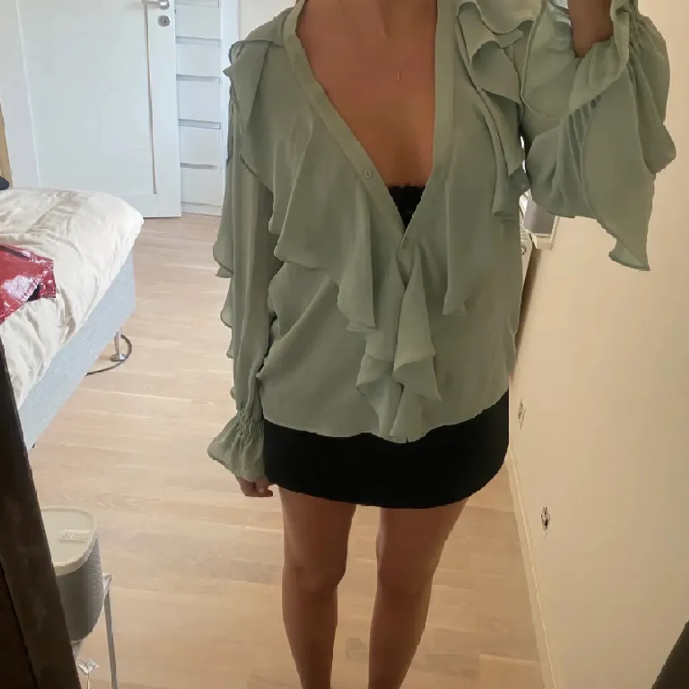 Säljer denna grön/blåa volang blus från zara. Ursnygg topp till fest men även till vardags, storlek xs men den passar även för small och medium💕skriv vid frågor. Blusar.