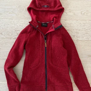 Stickad ziptröja från Peak performance - Knappt använd peak performance röd stickad zip. Superskön storlek S men ligger mest bara i garderoben. 