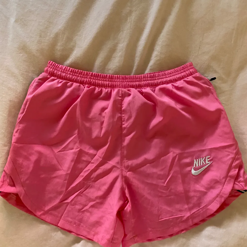 Säljer ett par rosa träningsshorts från Nike! Enbart testade så de är i nyskick, Strl M men är små i strl!!. Sportswear.