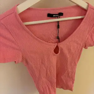 Rosa rivbbad U-ringad T-shirt. Storlek S. Från Bik Bok. Säljer eftersom den inte längre passar.