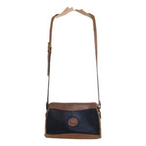 Vintage Dooney & Bourke Crossbody bag in black and brown leather.  Good vintage condition but has visible signs of wear.