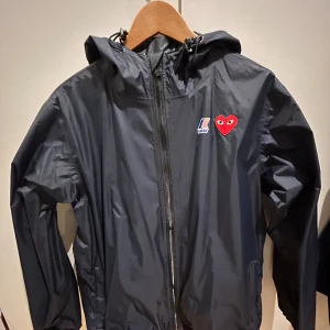 Cdg X K-way windbreaker  - Cdg X K-way windbreaker  Köpt på Paul and friends för 2000kr. Condition 9/10  Använd ett fåtal gånger, inga skador eller liknande. Fler bilder finns osv 