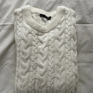 Kabelstickad Tröja - Snygg vit stickad tröja från Lager 157, endast använd en gång. Inköpt för 200 kr i höstas. Perfekt nu inför våren!! Passar folk mellan 175-185 cm skulle jag nog säga, beroende på hur man vill att den ska sitta. Skriv vid frågor eller fler bilder!!!