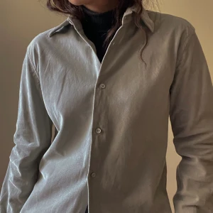Vintage Jil Sander Corduroy Top - Vintage Corduroy Top by Jil Sander in a sage green color. Features tonal colored buttons. Excellent Condition. Made in Italy.  Model Is 160cm (5”3) And Generally Fits XS/S  72 CM/ 28.3 IN Length 66 CM/ 26 IN Sleeve 42 CM/ 16.5 IN Shoulders 90 CM/ 35.