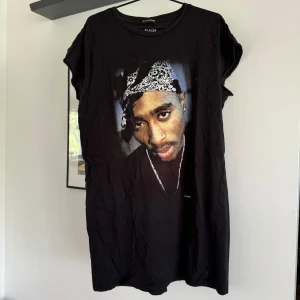 T-shirt klänning - Oversized t-shirt klänning med Tupacs ansikte på. Ärmarna är klippta av förra ägaren. Det står storlek 12, jag skulle säga M.   Katt finns i hemmet! 