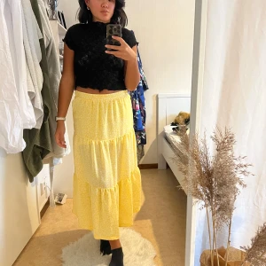 Gul somrig maxikjol - Superfin gul maxi kjol med vita blommor, tycker den är lite kort på mig som har 32 i byxlängd och är 170! Använd 2 gånger