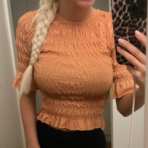Topp - Jätte fin orange brun topp med lite struktur och lite volanger i storlek xs, aldrig använd, köpt på Gina tricot 