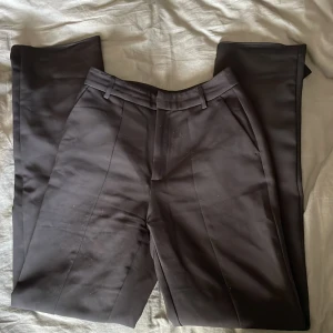 Kostymbyxor med slits  - Snygga högmidjade kostymbyxor från stradivarius (strl 34). Kostymbyxorxorba har slits där fram på byxbenen längst ner . Säljer pga att det är för små för mig. 