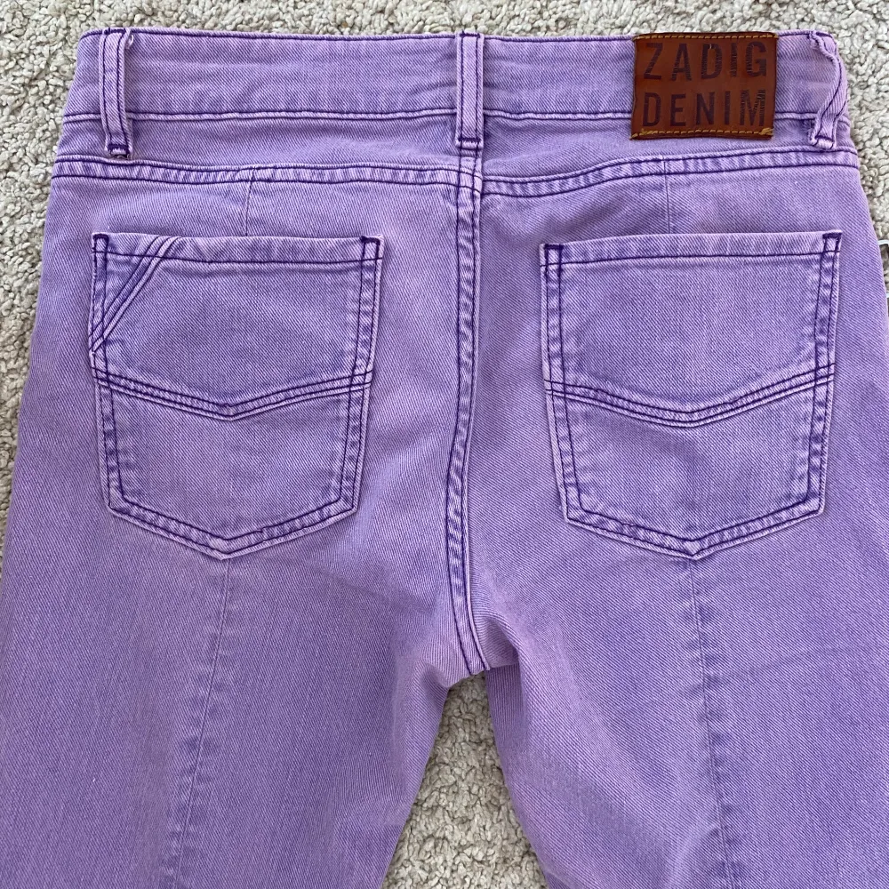 Unika, lila denim jeans från Zadig &Voltaire - low waist och bootcut. Sjukt snygga och nyskick! 38 cm över midjan och ca 75 cm i innerbenslängd.  Nypris 2 480 kr. Jeans & Byxor.