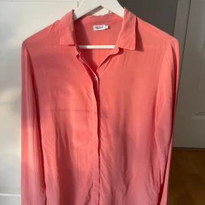 Silkesskjorta - Filippa K  - Vad: Skjorta från Filippa K Färg: Rosa/Cerise  Storlek: S Skick: Använd i fint skick. En bläckpenna har kommit mot, se bild.   Material: 100% silke