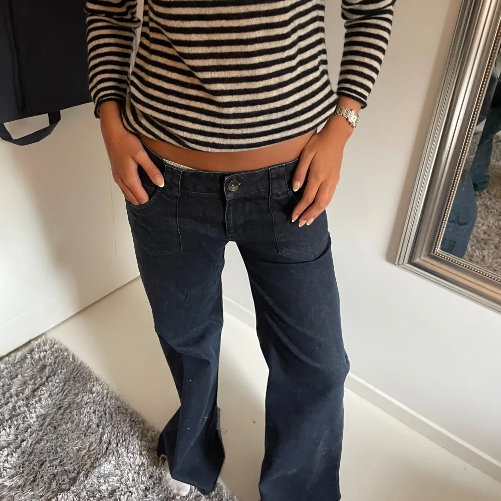 Säljer dessa jättesnygga lågmidjade jeans som är marinblå och passar en S möjligen en liten M. Jeans & Byxor.