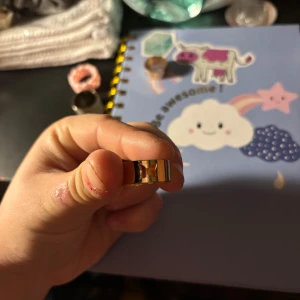 Ring - En guldfärgad ring med en fjäril på