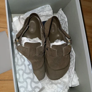 Dior/ Birkenstock - Ett par super fina Dior x Birkenstock tofflor klpt förra sommarn från hemsidan för 12 000kr, box och autentifierings bevis följer med. Storlek 36 men herrstorlek och passar mig perfekt som har 37/38!!!!