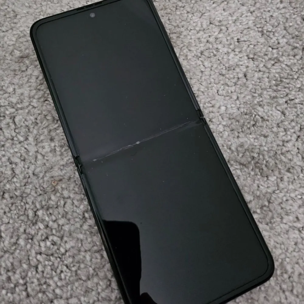  Använd – i gott skick Galaxy Z Flip3 5G (SM-F711B) Färg: svart 128GB i lagringsminne 8GB ramminne. Finns en repa på stora skärmen, inget som påverkar funktionen. Bra batteri.  Original kartong medföljer, se bilder.  . Övrigt.