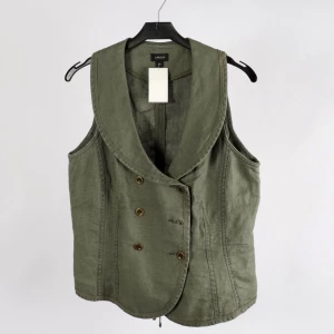 Snygg väst i 100% linne stl 40 - Jätte fin väst i 100% linne från Lindex i stl 40, men snörning baktill så man kan snöra den hårdare eller läsare efter sin kroppsform. Stl är en figurnära M) Mycket fint skick! Snygg till en maxikjol som den är eller över en topp till ett par jeans. 