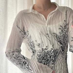 Genomskinlig vit skjorta / blus - Sitter superfin och går in i midjan. Lite missfärgad på ena ärmen vid handen som visas.