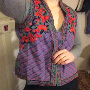 A cool embroidered vest with patterns and flowers 
