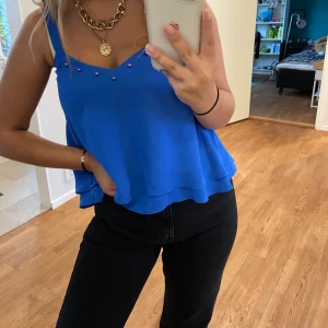 Blått linne med pärlor - Ett blått linne med pärlor på längst med bystkanten. Super snyggt!! Ändast använt en gång (under den a bild) för den är för liten kring bysten :(