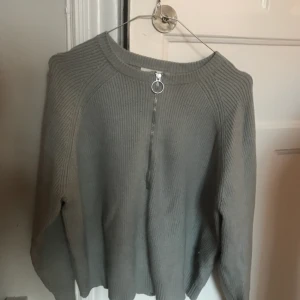  - Stickad tröja från Carin Wester för Åhléns. Ljusgrå/blå. Använd några gånger. Lite kortare modell, så snygg på. 