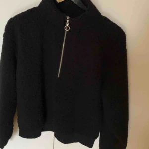  - Skön, varm fluffig tröja med dragkedja i halsen. Har en liten ”strävhet” på ena armen då jag råkade hålla armen över ett ljus. Ingenting som syns. Frakt tillkommer.