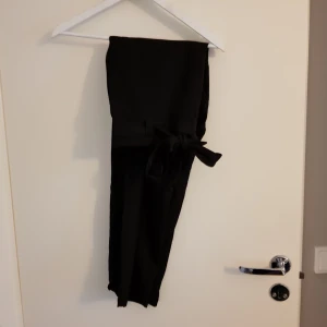  - Höga byxor från H&M, storlek 40. Använda en gång så i princip nyskick. Säljer pga av att jag kändr att de var för stora. Knytband i midjan. Köparen står för frakt 50 kr.
