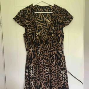  - Klänning i leopard och knytning i midjan. V-ringad och skönt material. Mycket bra skick!