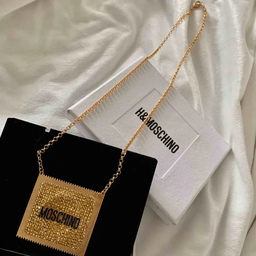Helt Ny och Unik Moschino halsband från H&M i samarbete med Moschino i form av en kondom. De har tillverkats i begränsad antal så det är definitivt en unik exemplar.  Size of pendant 5.5x6 cm. Length of necklace 66 cm.. Accessoarer.