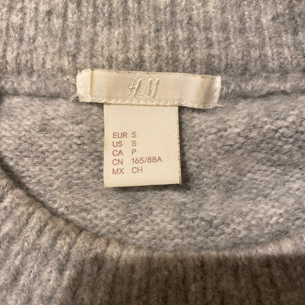 Grå stickad tröja med fina detaljer på. Säljer då den inte kommer till användning. I storlek S men passar även mindre och större, beror på hur man vill att den ska sitta. Säljer för 150 + frakt (66kr). Stickat.