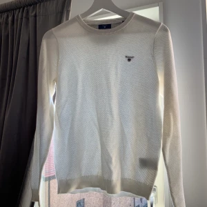 Vit finstickad GANT tröja - En jättefin stickad tröja från GANT, inköpd för ca 3 år sedan men endast använd 1-2 gånger. Säljes just pga den anledningen, att den inte används! Storlek S men skulle säga att den sitter relativt tajt så passar mer en XS enligt mig! NYPRIS: 1.499kr