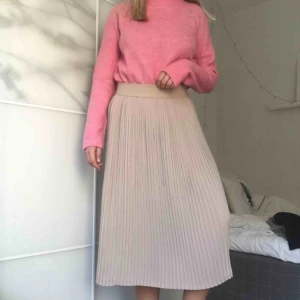  - Veckd beige kjol med resår. Mycket skön och flowig. Köpt second hand. Frakt ingår ej.