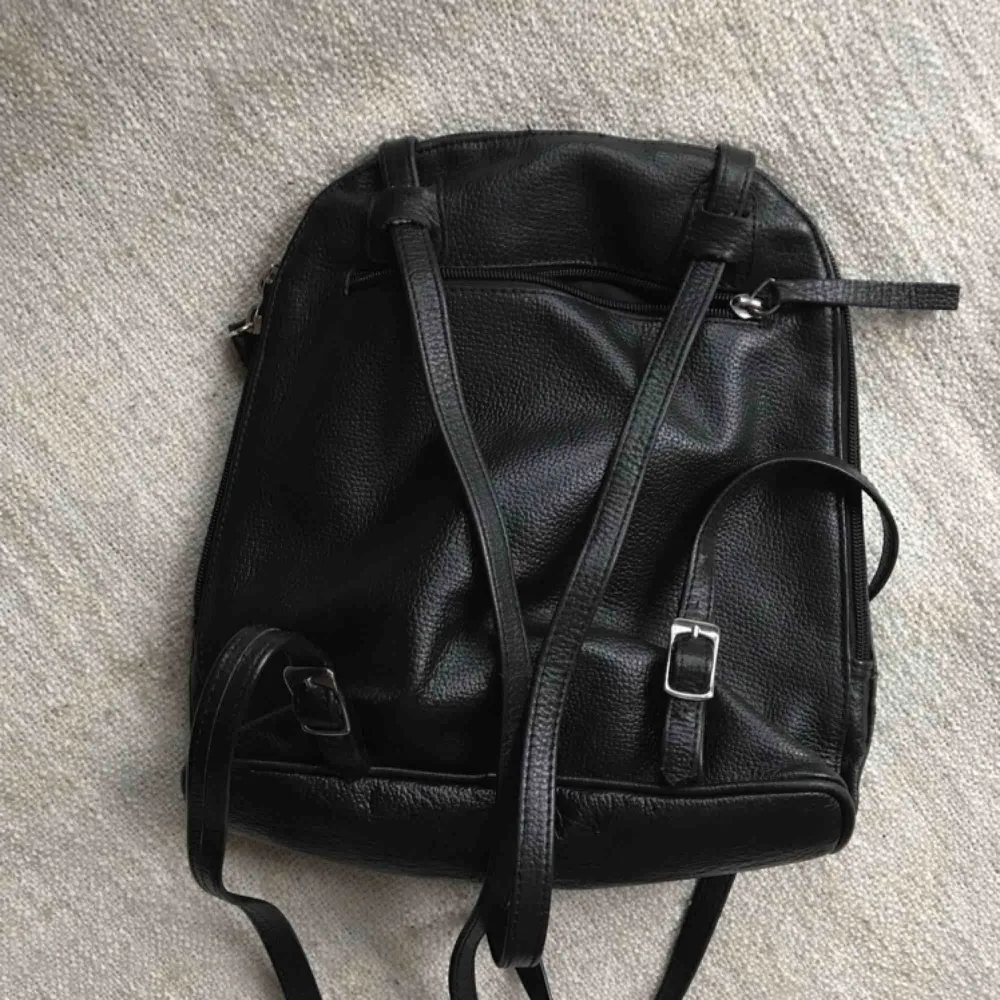 Black soft leather mini-bag. Perfect condition. Lots of pockets. Shipping is extra.. Väskor.