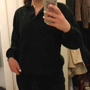  - Jättefin svart glittrig tjocktröja med krage. Köpt på en second hand i Paris. Inga synliga defekter. Gott skick! Ingen angiven storlek eller märke men skulle gissa på s/m. Möts i innerstan/köparen står för frakt.💜