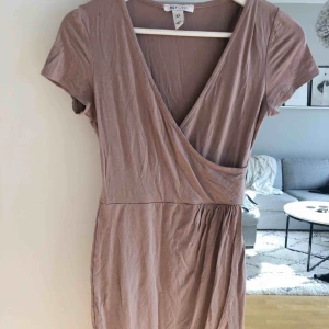  - T-shirt klänning från NLY ONE. Omlott både upptill och nedtill. Nudefärgad. Superfin!! Flitigt använd men är i bra skick!