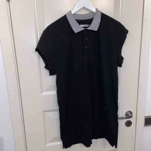  - En svart piketröja med vit-grå krage. Använd en gång. Ärmarna är klippta lite halvslvarvigt.✨🌼