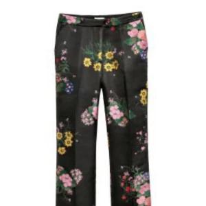  - ERDEM x H&M. Ett par ankellånga kostymbyxor i stadig, jacquardvävd kvalitet med skimrande mönster. Byxorna har blommiga broderier med inslag av glittertråd. Vida, raka ben med pressveck och normalhög midja. Sidfickor och passpoalerade bakfickor. Gylf med dragkedja och knapp samt förlängd linning med dold knapp