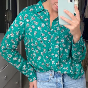 Blommig skjorta  - Skön avslappnad skjorta från Gina! Blommig med grön bakgrund🌸 knappt använd och kommer från ett djur och rökfritt hem! Köpare står för frakt 💛 