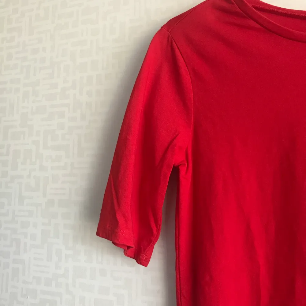 Röd tshirt som är längre i ärmarna, längre baktill och har en slits där nere!. T-shirts.