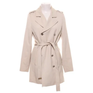 Kapp från STOCKH LM i strl 36 - Snygg ljus beige kappa från märket STOCKH LM i storlek 36. Sitter som en smäck och har silvriga knappar samt band i midjan. Väldigt sparsamt använd och säljs pga flyttrensning. Nypris 999kr. 🤗🤗🤗 Perfekt till hösten. 