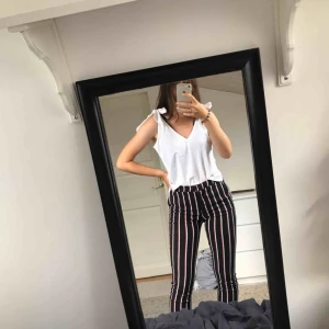  - Tunna randiga byxor. Stretchiga. Svarta med röda och vita ränder. Korta ben med slits nertill.  Mötas upp eller köparen står för frakten. 